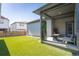 Serene backyard showcasing a lush lawn, an outdoor patio area, and privacy fencing at 21574 E 59Th Dr, Aurora, CO 80019