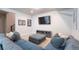 Finished basement living area with comfortable seating and a large television at 21574 E 59Th Dr, Aurora, CO 80019