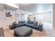Finished basement living area with comfortable seating, exercise bikes, and movie posters at 21574 E 59Th Dr, Aurora, CO 80019