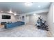 Spacious basement featuring plush carpet, a comfortable seating area, and workout equipment at 21574 E 59Th Dr, Aurora, CO 80019