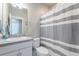 Bright bathroom featuring modern fixtures, granite vanity, and a shower with a striped curtain at 21574 E 59Th Dr, Aurora, CO 80019