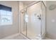 Bathroom featuring tile enclosed shower with glass door next to bright window at 21574 E 59Th Dr, Aurora, CO 80019