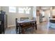 Dining area with wood table and chairs next to white kitchen and stainless steel appliances at 21574 E 59Th Dr, Aurora, CO 80019