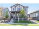 Charming two-story home with a well-manicured lawn and inviting front porch, perfect for suburban living at 21574 E 59Th Dr, Aurora, CO 80019