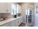 Well-lit kitchen featuring quartz countertops, stainless appliances, and a convenient walk-in pantry at 21574 E 59Th Dr, Aurora, CO 80019
