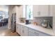 Bright kitchen with quartz countertops, stainless steel refrigerator, and modern appliances at 21574 E 59Th Dr, Aurora, CO 80019