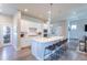 Bright, open kitchen with an island featuring bar seating, and stainless steel appliances, perfect for entertaining at 21574 E 59Th Dr, Aurora, CO 80019
