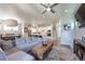 Open-concept living area with hardwood floors, a sectional sofa, and a view of the kitchen at 21574 E 59Th Dr, Aurora, CO 80019
