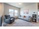 Cozy living room with comfortable seating, large windows, and neutral decor at 21574 E 59Th Dr, Aurora, CO 80019