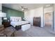 Large main bedroom with a patterned bedspread, ceiling fan, and bedside tables at 21574 E 59Th Dr, Aurora, CO 80019