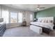 Spacious main bedroom with large windows, plush carpet, and a ceiling fan at 21574 E 59Th Dr, Aurora, CO 80019