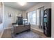 Home office with a large desk, comfortable chair, and natural light from the window at 21574 E 59Th Dr, Aurora, CO 80019