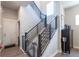 Modern staircase with metal railing and wood steps leading to the upper level at 21574 E 59Th Dr, Aurora, CO 80019