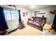 bedroom with a built in bookshelf headboard, room to play, and a large window at 19930 E Cornell Ave, Aurora, CO 80013