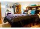 Cozy bedroom featuring a comfortable bed, built-in storage, and a charming vanity area at 19930 E Cornell Ave, Aurora, CO 80013