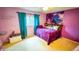 Cozy bedroom featuring bright pink walls, closet space, and natural light at 19930 E Cornell Ave, Aurora, CO 80013