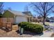 Side view showing the home's exterior with attached garage, fenced yard, and mature landscaping at 19930 E Cornell Ave, Aurora, CO 80013