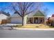 Charming front exterior with a well-kept lawn, mature trees, and a welcoming entrance with a bench at 19930 E Cornell Ave, Aurora, CO 80013