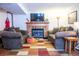 Spacious living room with comfortable seating, fireplace, and a large television at 19930 E Cornell Ave, Aurora, CO 80013