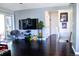 Bright living area with hardwood floors, a TV, and a sliding glass door that leads to an outdoor area at 19930 E Cornell Ave, Aurora, CO 80013