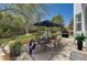 Backyard patio features an outdoor dining set with an umbrella and a grill at 2950 Wyecliff Ln, Highlands Ranch, CO 80126