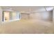 Spacious finished basement is carpeted and has a doorway to the bathroom and storage at 2950 Wyecliff Ln, Highlands Ranch, CO 80126