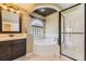 Elegant bathroom with separate tub and shower, vanity, decorative mirror, and tiled walls at 2950 Wyecliff Ln, Highlands Ranch, CO 80126