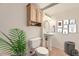 Bright bathroom featuring a pedestal sink, oval mirror, and cabinet above the toilet at 2950 Wyecliff Ln, Highlands Ranch, CO 80126