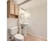 Charming half bath featuring a pedestal sink, cabinet, and modern lighting fixtures at 2950 Wyecliff Ln, Highlands Ranch, CO 80126