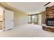 Bedroom showcasing a stone fireplace and bay window with backyard views at 2950 Wyecliff Ln, Highlands Ranch, CO 80126