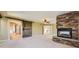 Spacious bedroom featuring a stone fireplace, barn door to bath, and a walk-in closet at 2950 Wyecliff Ln, Highlands Ranch, CO 80126