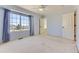 Bright bedroom boasts a large window with curtains, neutral carpet, and a ceiling fan at 2950 Wyecliff Ln, Highlands Ranch, CO 80126