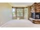 Cozy bedroom featuring a fireplace and windows with a backyard view at 2950 Wyecliff Ln, Highlands Ranch, CO 80126