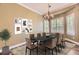 Formal dining room featuring modern chandelier, a large window with bright natural light, and stylish decor at 2950 Wyecliff Ln, Highlands Ranch, CO 80126