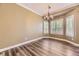 Dining area featuring hardwood floors, large windows with plantation shutters, and a chandelier at 2950 Wyecliff Ln, Highlands Ranch, CO 80126