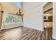 Bright dining area with hardwood floors, chandelier, large window, and view into the kitchen at 2950 Wyecliff Ln, Highlands Ranch, CO 80126