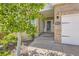 Charming front entrance with brick facade and decorative house number; mature trees enhance curb appeal at 2950 Wyecliff Ln, Highlands Ranch, CO 80126