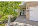 Inviting front entrance of a brick home with a decorative address plaque and landscaped planters at 2950 Wyecliff Ln, Highlands Ranch, CO 80126