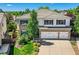 Beautiful two-story home with a three-car garage, tile roof, and a combination of brick and white siding at 2950 Wyecliff Ln, Highlands Ranch, CO 80126