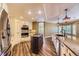 Bright kitchen showcasing custom cabinetry, granite countertops, an island, and stainless-steel appliances at 2950 Wyecliff Ln, Highlands Ranch, CO 80126