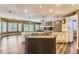 Large kitchen with granite counters, stainless appliances, central island, and adjacent living area with fireplace at 2950 Wyecliff Ln, Highlands Ranch, CO 80126