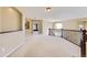 Open landing area features neutral carpet and a wrought iron banister overlooking the space below at 2950 Wyecliff Ln, Highlands Ranch, CO 80126