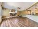 Open-concept living space featuring a stone fireplace, ceiling fan, hardwood floors, and a kitchen at 2950 Wyecliff Ln, Highlands Ranch, CO 80126