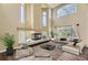 Bright living room boasts soaring ceilings and fireplace feature at 2950 Wyecliff Ln, Highlands Ranch, CO 80126