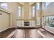 Bright living room features soaring ceilings, fireplace, and windows at 2950 Wyecliff Ln, Highlands Ranch, CO 80126