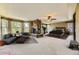 Bright main bedroom featuring a stone fireplace, sitting area, and large windows at 2950 Wyecliff Ln, Highlands Ranch, CO 80126
