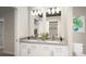 Bathroom featuring double sinks, modern fixtures, and a large mirror at 46541 Sunflower Ln, Bennett, CO 80102