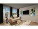 Bright living room with large windows, stylish decor, comfortable seating, and a contemporary design at 46541 Sunflower Ln, Bennett, CO 80102