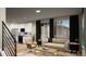Open-concept living room and kitchen with modern furnishings, large windows, and hardwood floors at 46541 Sunflower Ln, Bennett, CO 80102