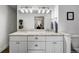 Bright bathroom showcasing a granite countertop, dual undermount sinks, and a shaker style vanity at 6869 S Niagara Ct, Centennial, CO 80112